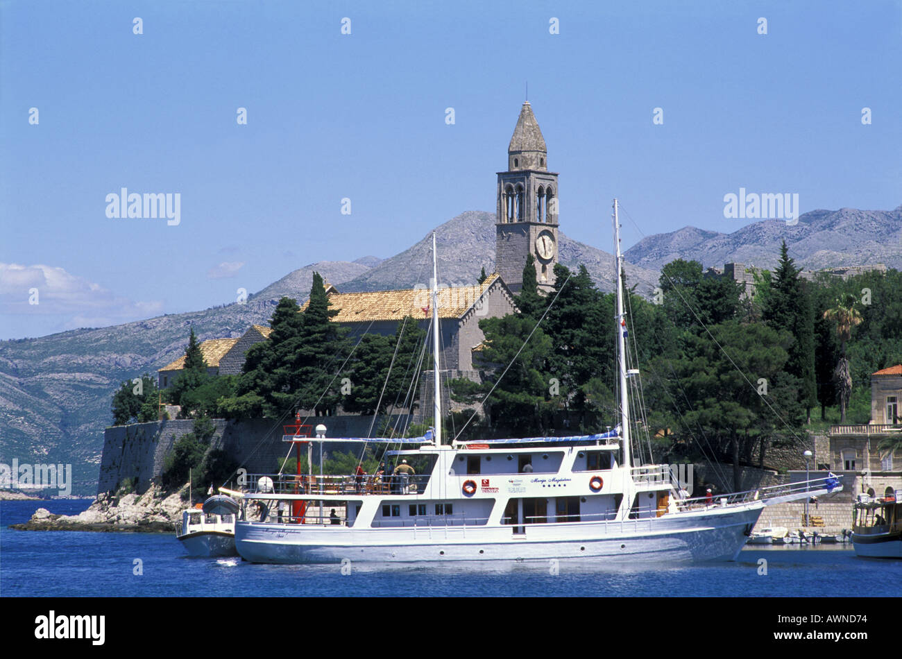 Ferry boat arriving at Lopud Island St Mary s Church in the background Elaphite Island Dalmatia Croatia Adriatic Sea Stock Photo