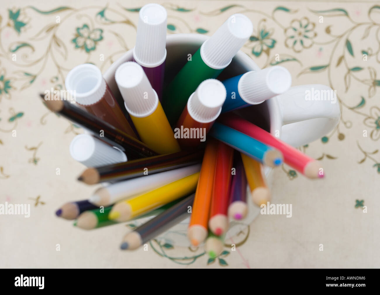 Mug full of colored pencils and markers, high angle view Stock Photo