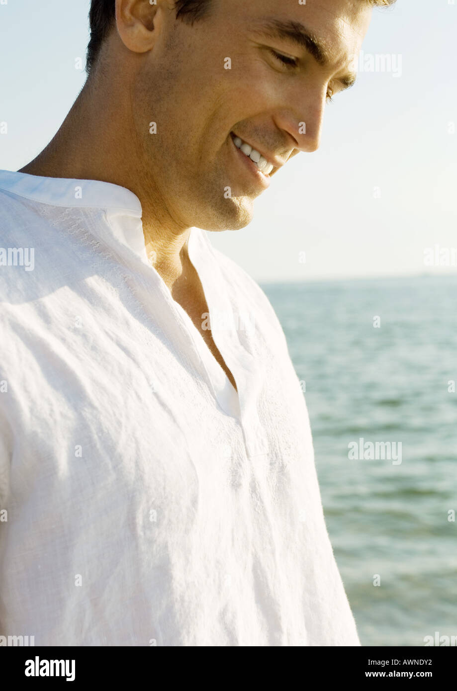 Man smiling, sea in background Stock Photo