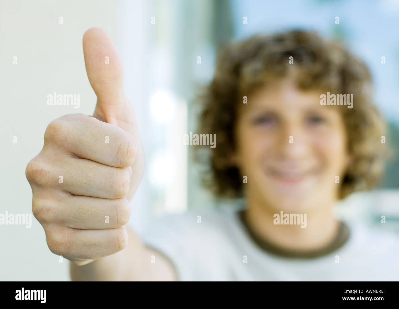 Preteen boy giving thumbs up Stock Photo