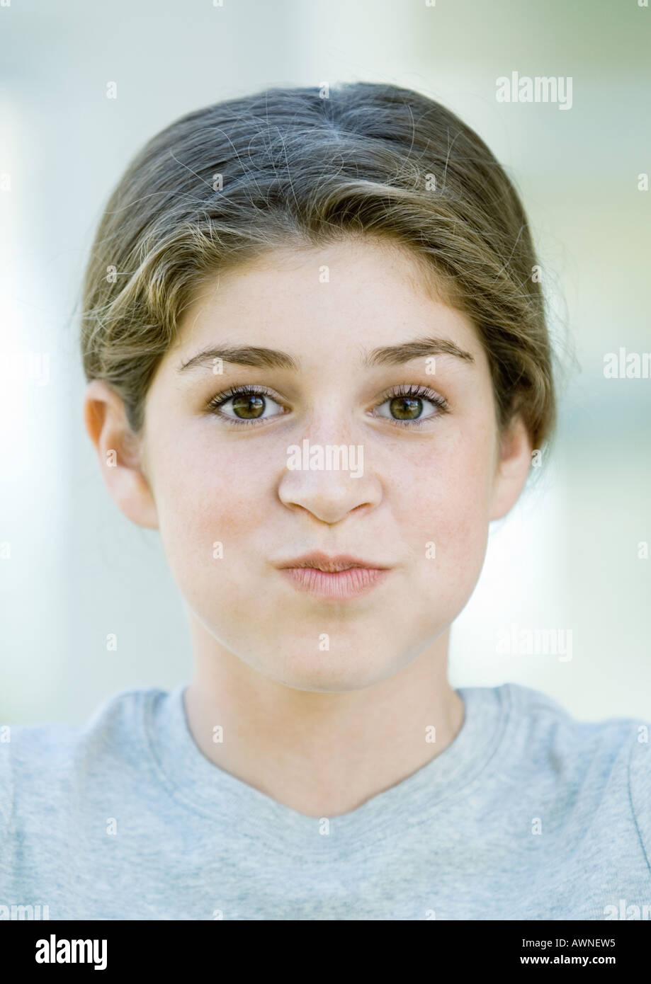 Preteen girl puffing out cheeks Stock Photo