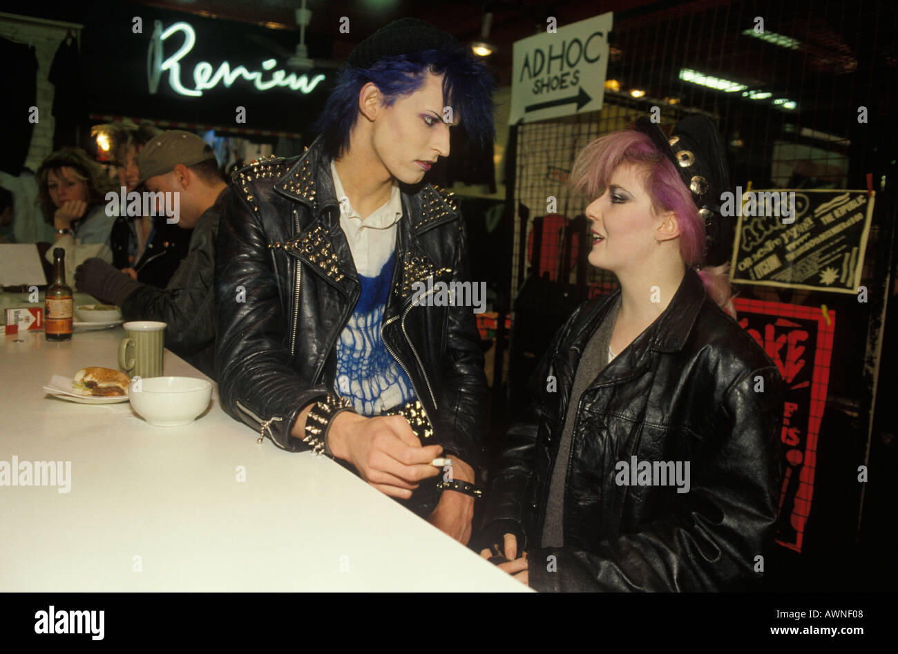 Punk couple 1980s UK. The Great Gear Market cafe Kings Road Chelsea, Wearing studded leather jackets and looking in fashion London. 1983 HOMER SYKES Stock Photo