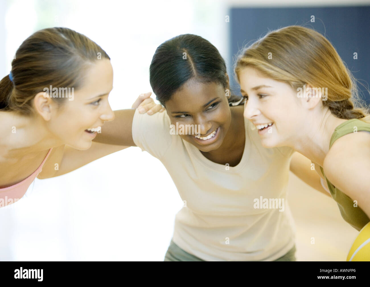 Three teenage girls huddling Stock Photo