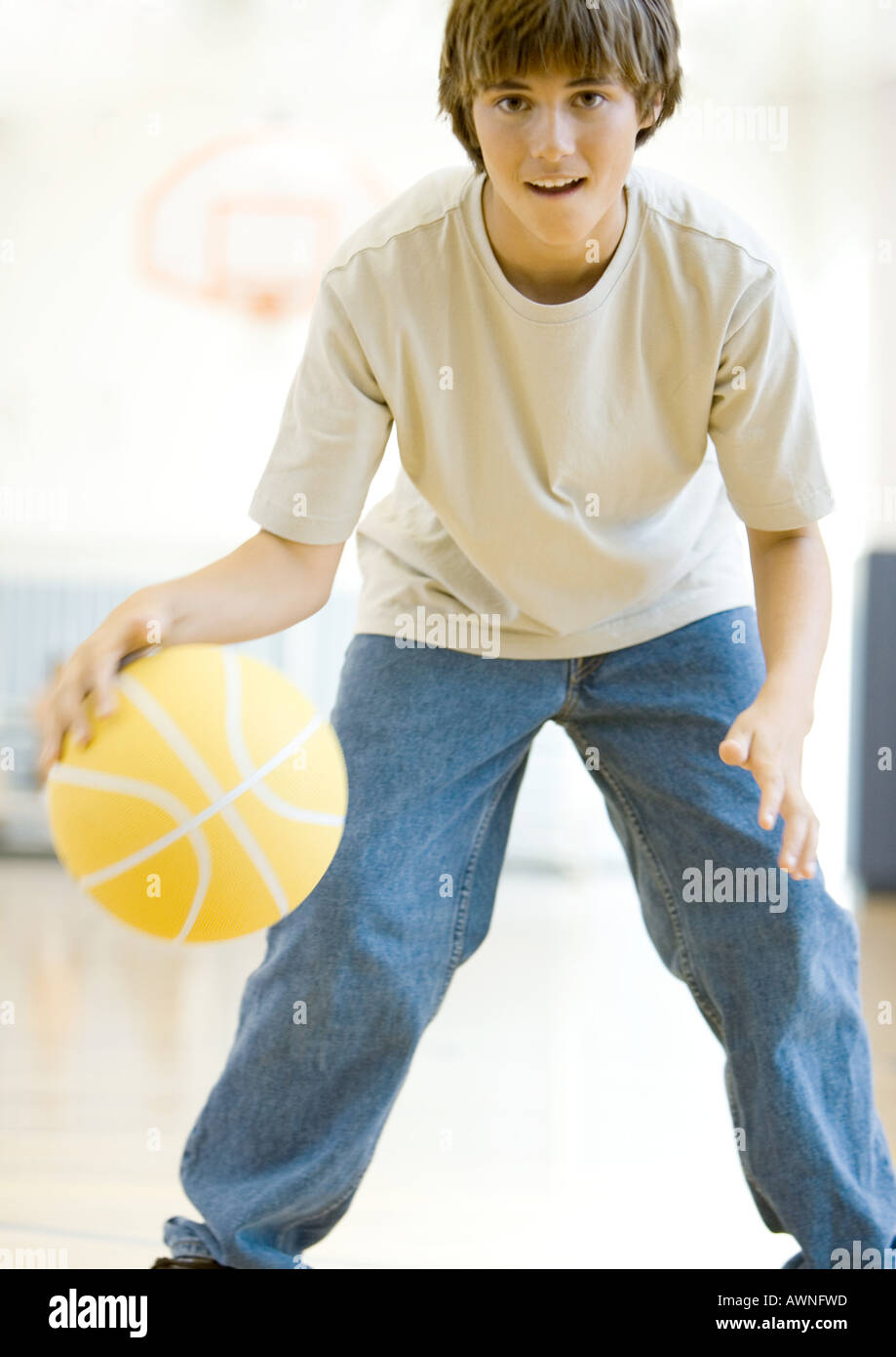 Teenage boy playing basketball Stock Photo