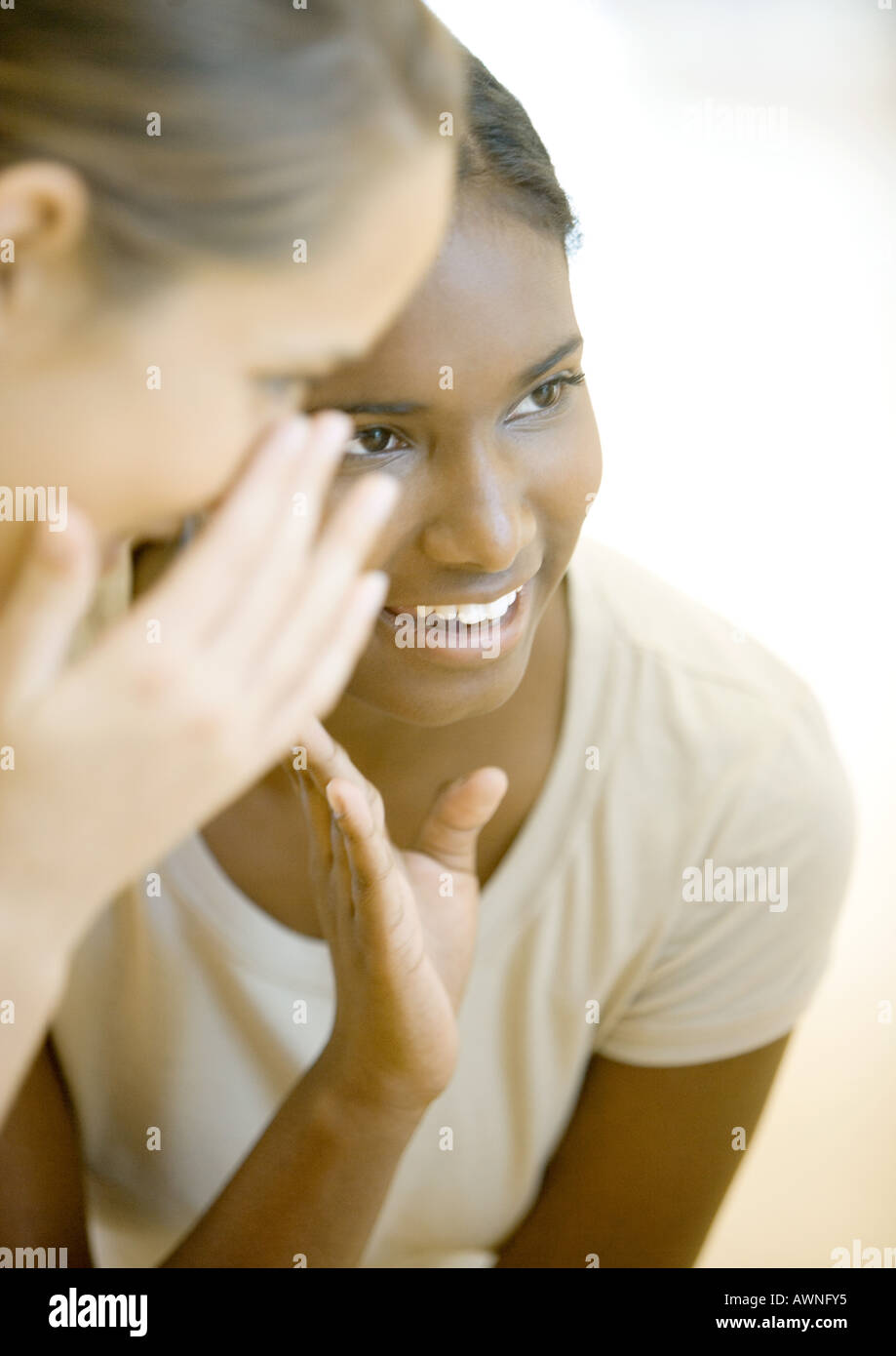 Two teen girls whispering Stock Photo - Alamy
