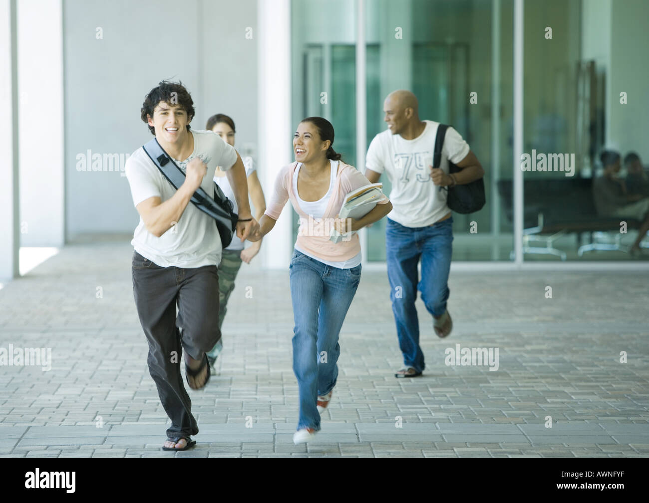 Group of students running on campus Stock Photo