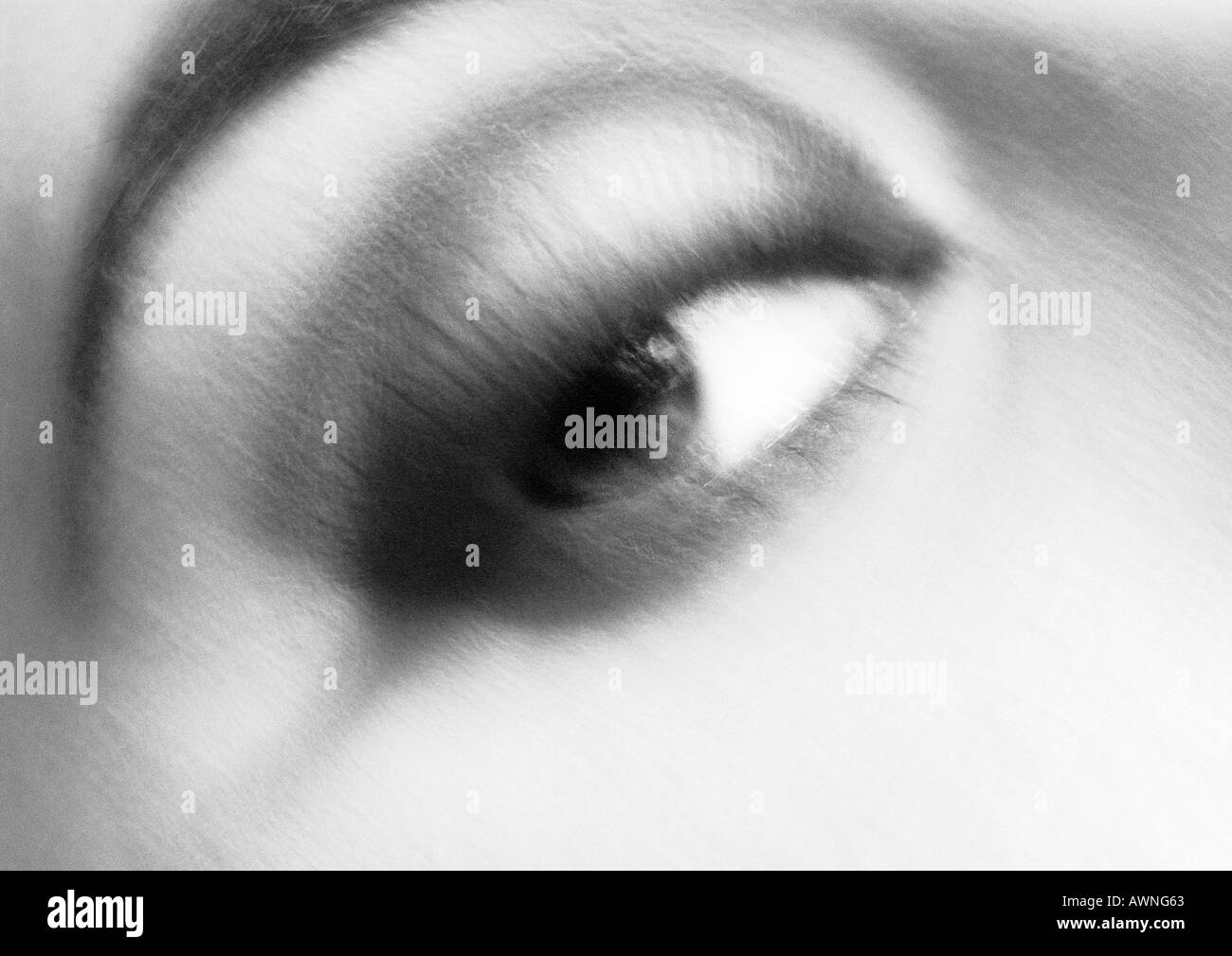 Woman's eye looking right, blurred black and white. Stock Photo