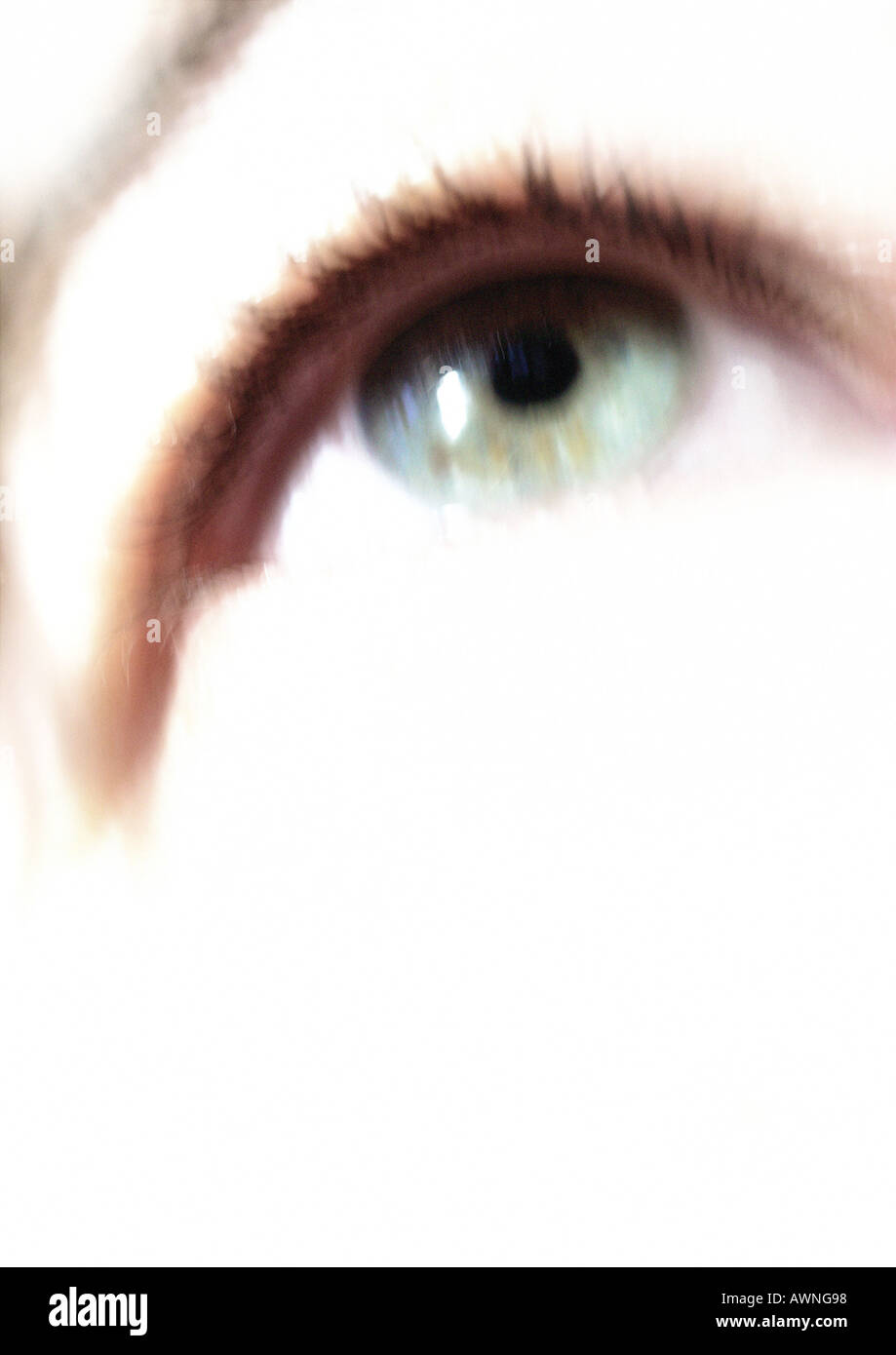 Woman's green-blue eye looking up, blurred close up. Stock Photo