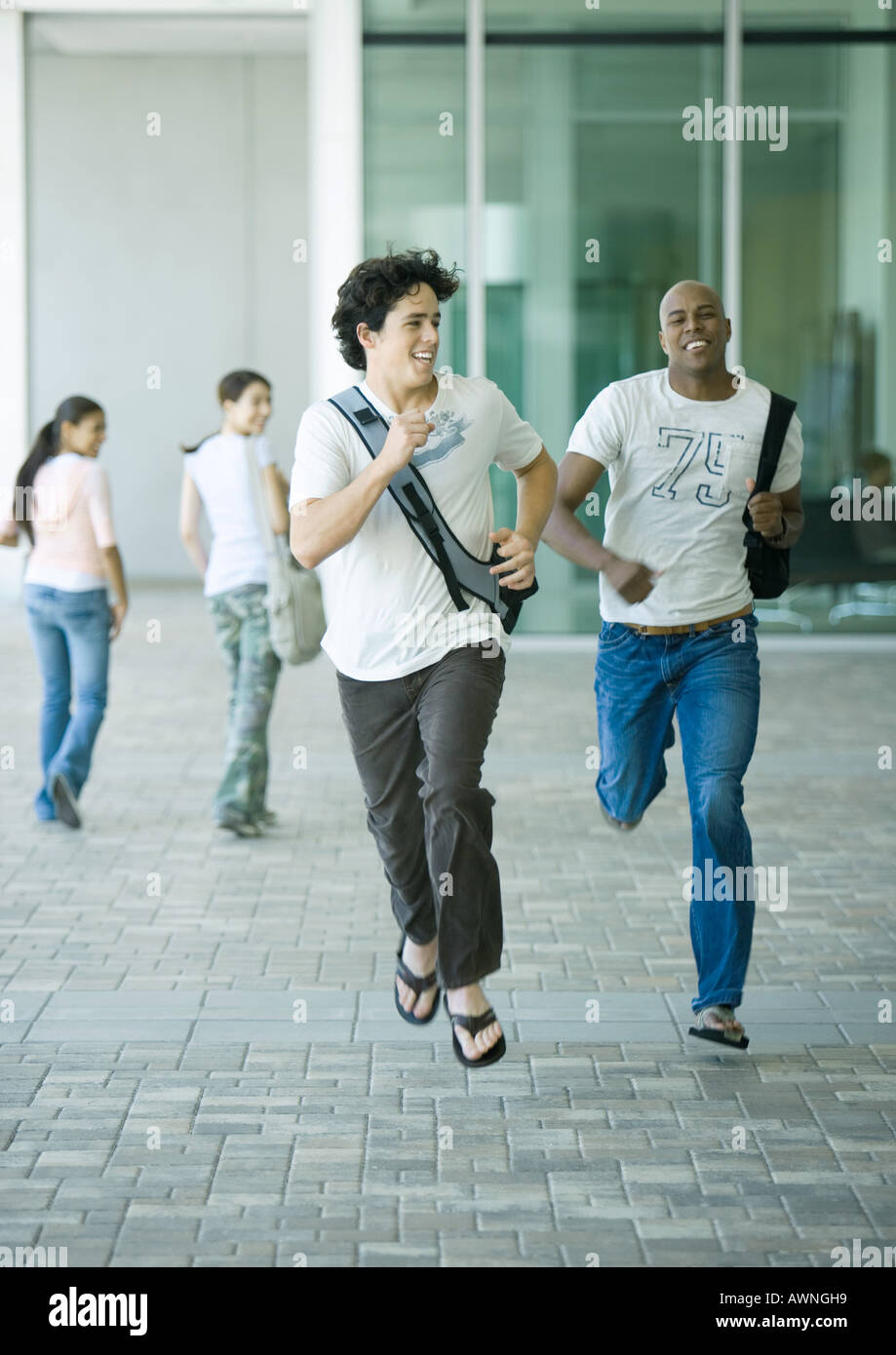 College students running on campus Stock Photo