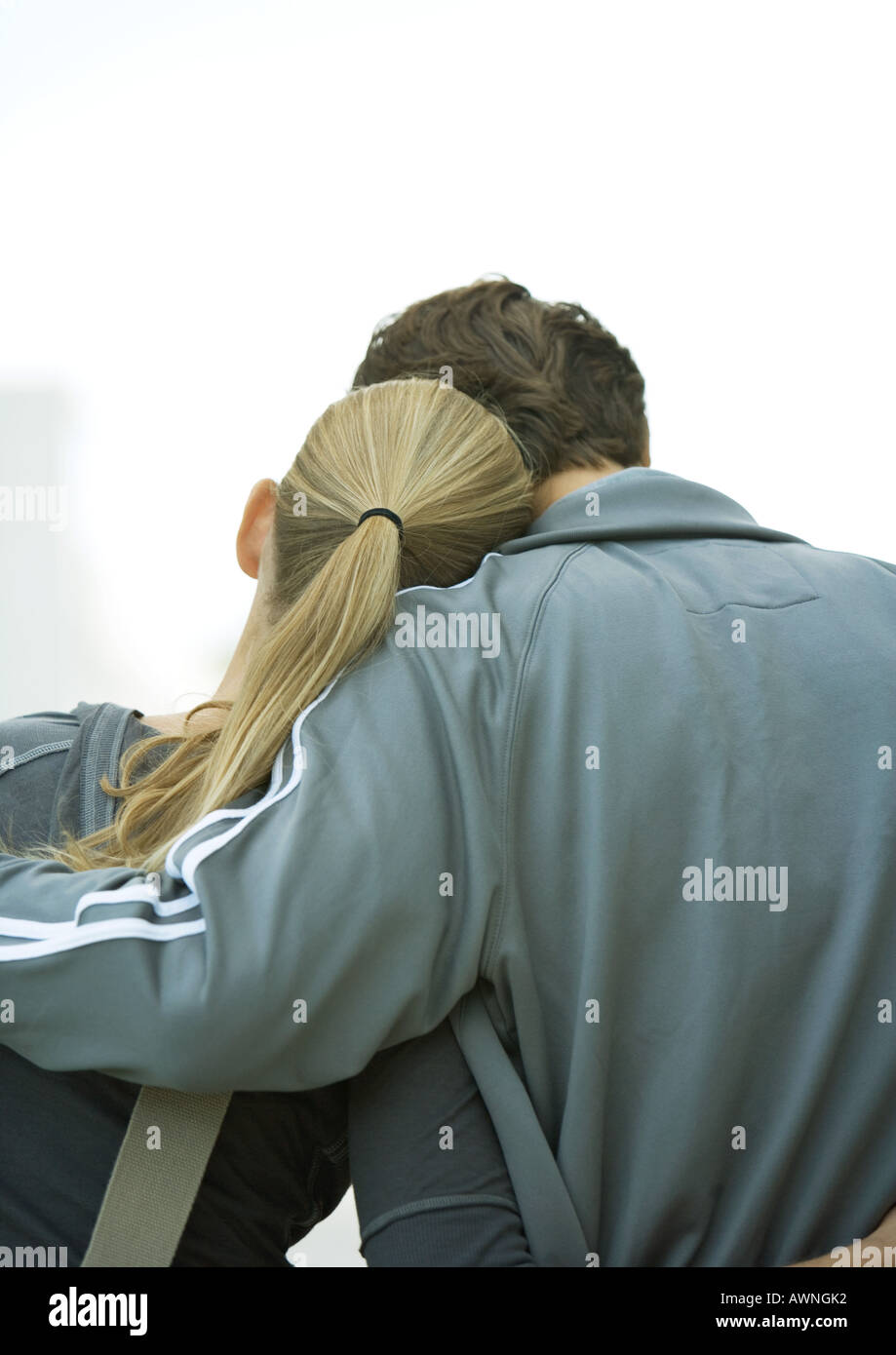 Young couple, woman's head on man's shoulder, rear view Stock Photo