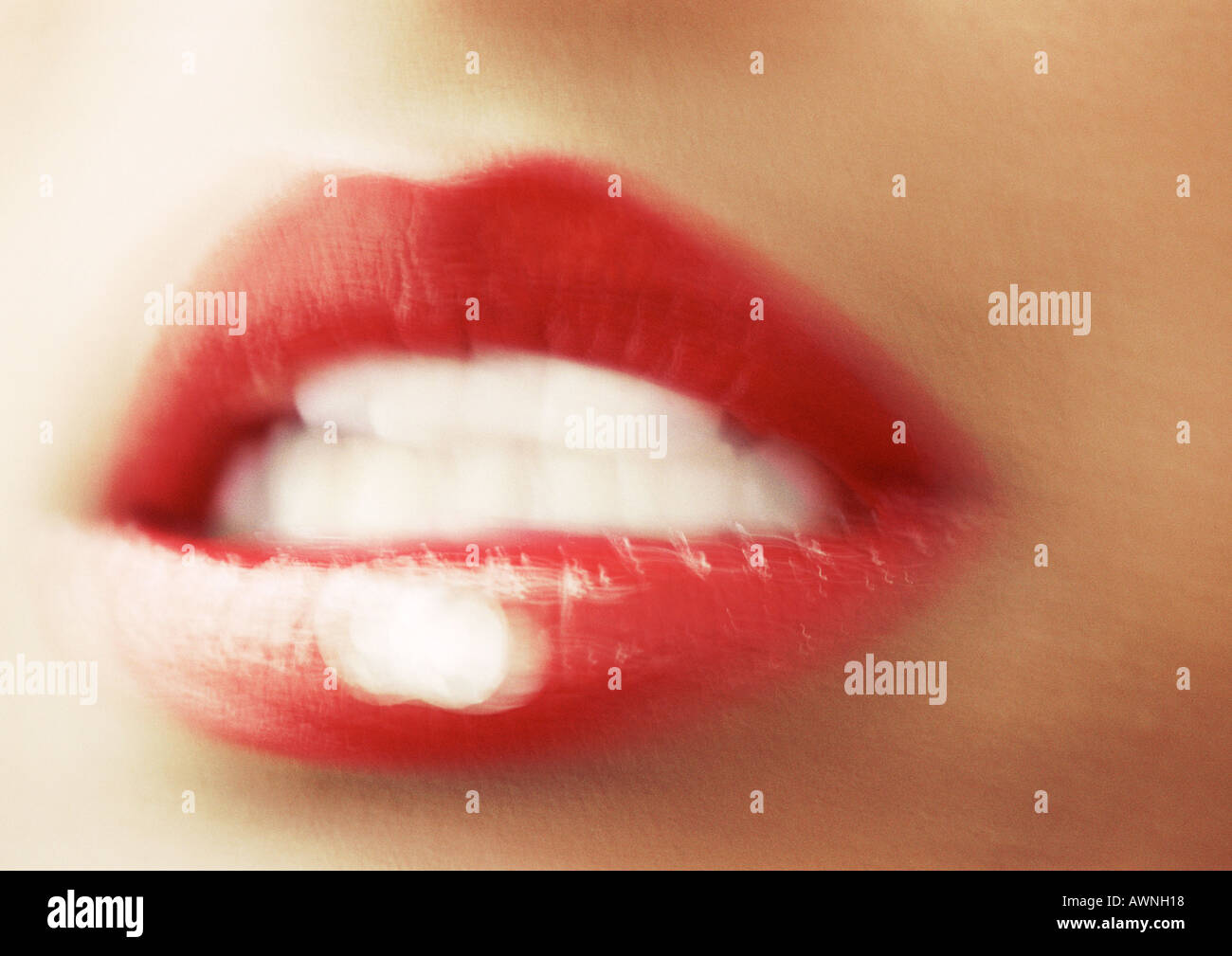 Woman wearing red lipstick, close up of open mouth, blurred. Stock Photo