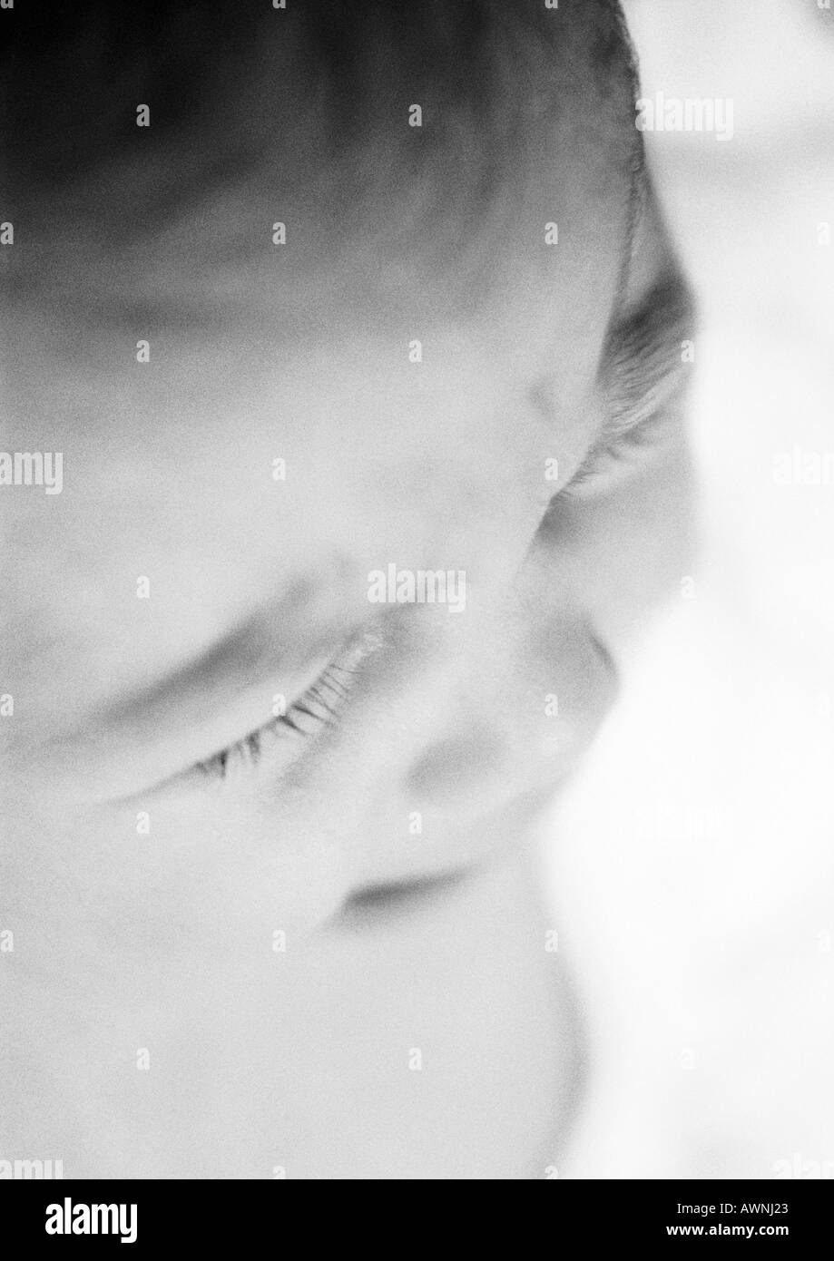 Baby crying, close-up, high angle view, B&W. Stock Photo