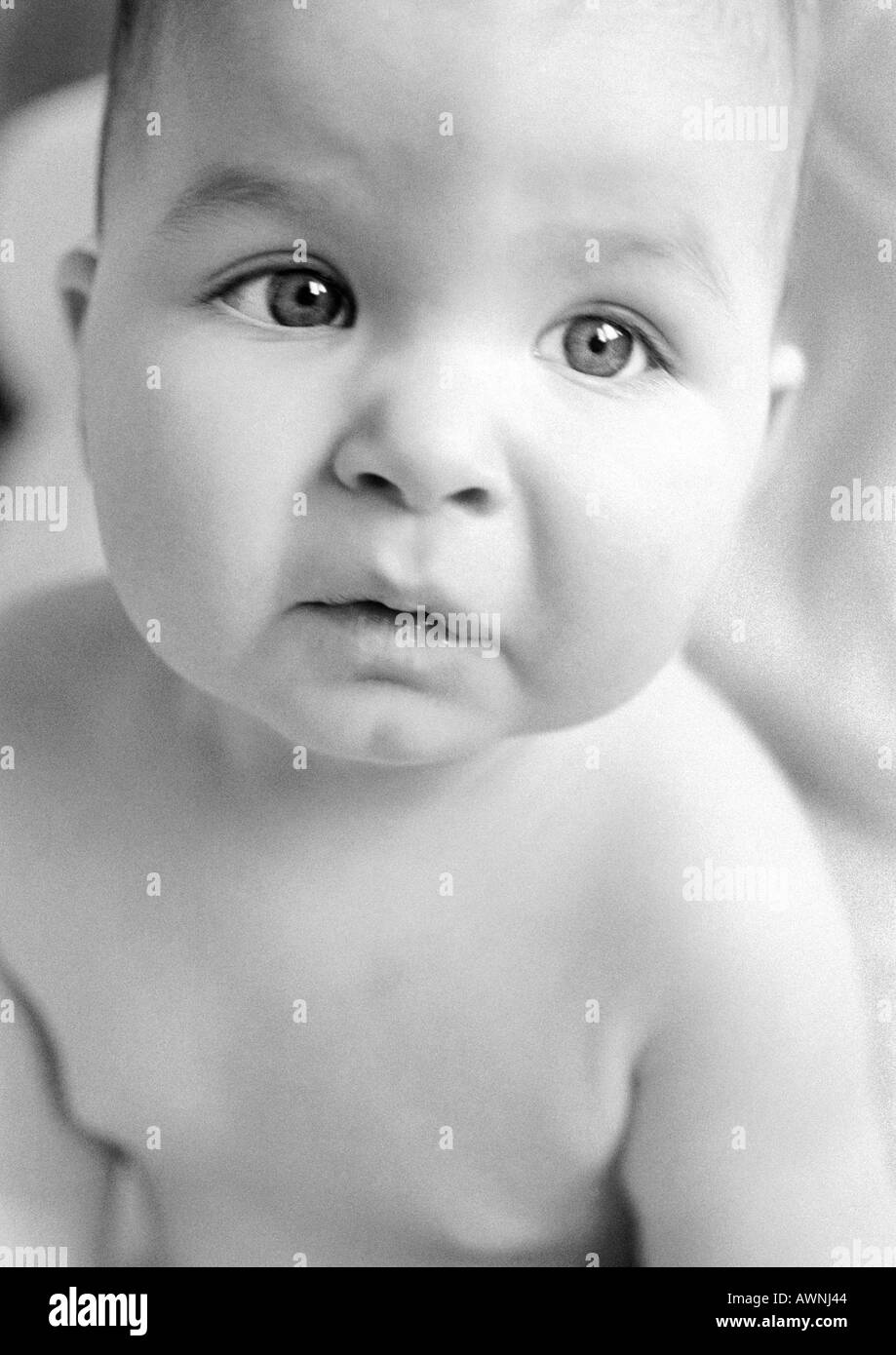 Baby looking up, close-up, B&W. Stock Photo