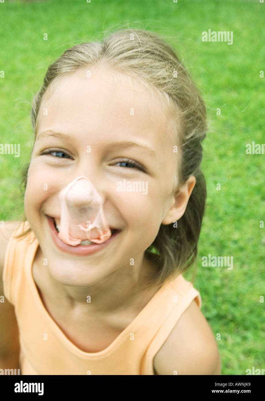 Girl with popped gum bubble on nose Stock Photo