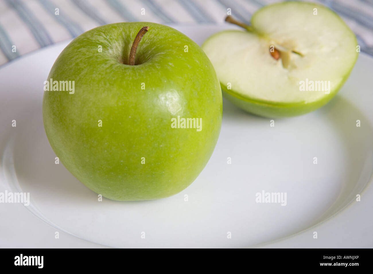 Green apple on a plate Stock Photo