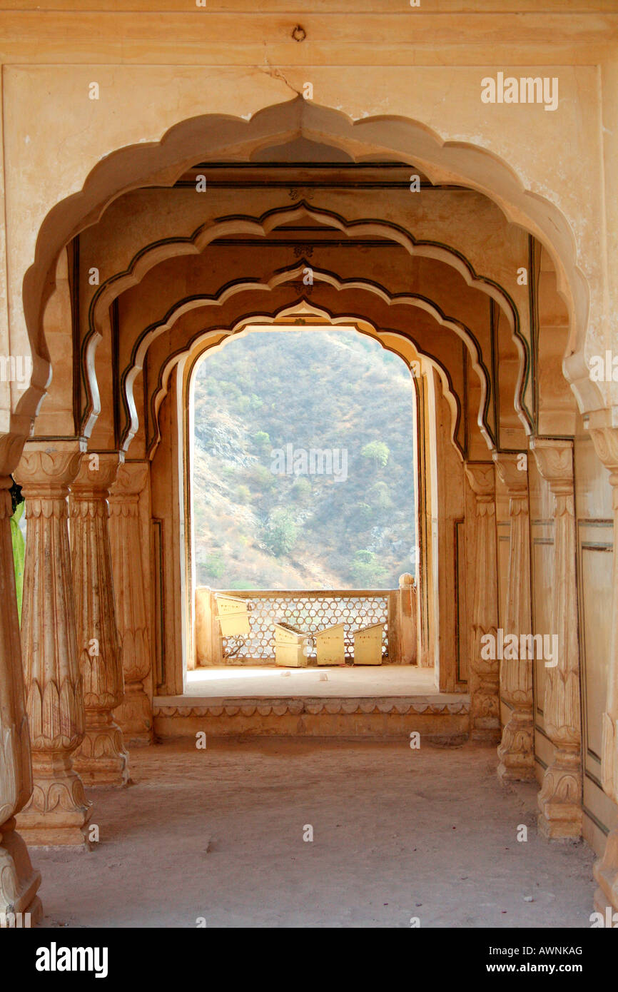 Hallway of arches and pillars in Amber Fort near Jaipur Rajasthan North India. The view looks towards hills Stock Photo