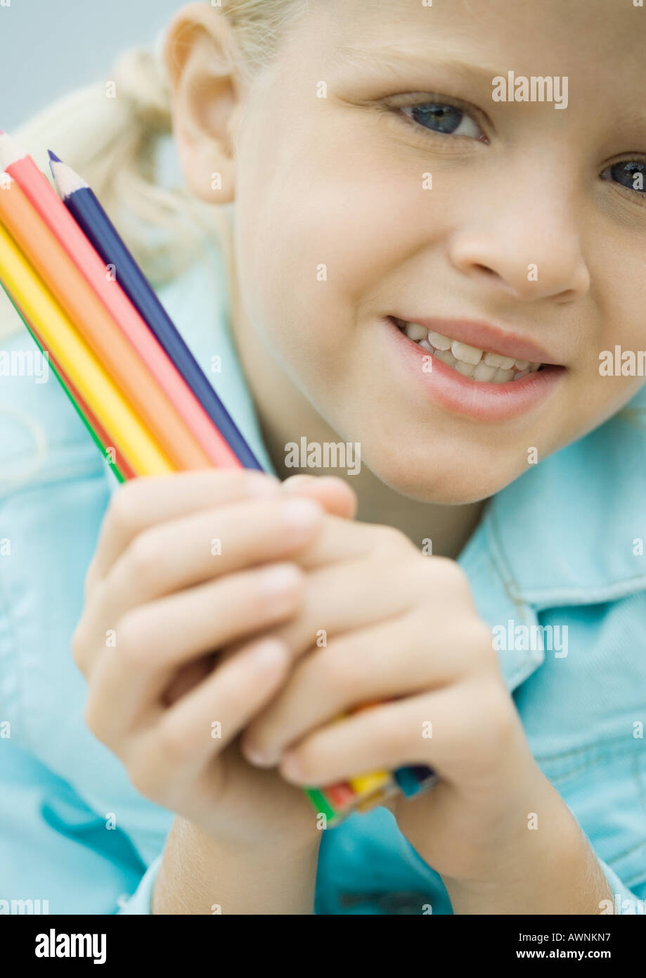 Girl holding colored pencils Stock Photo