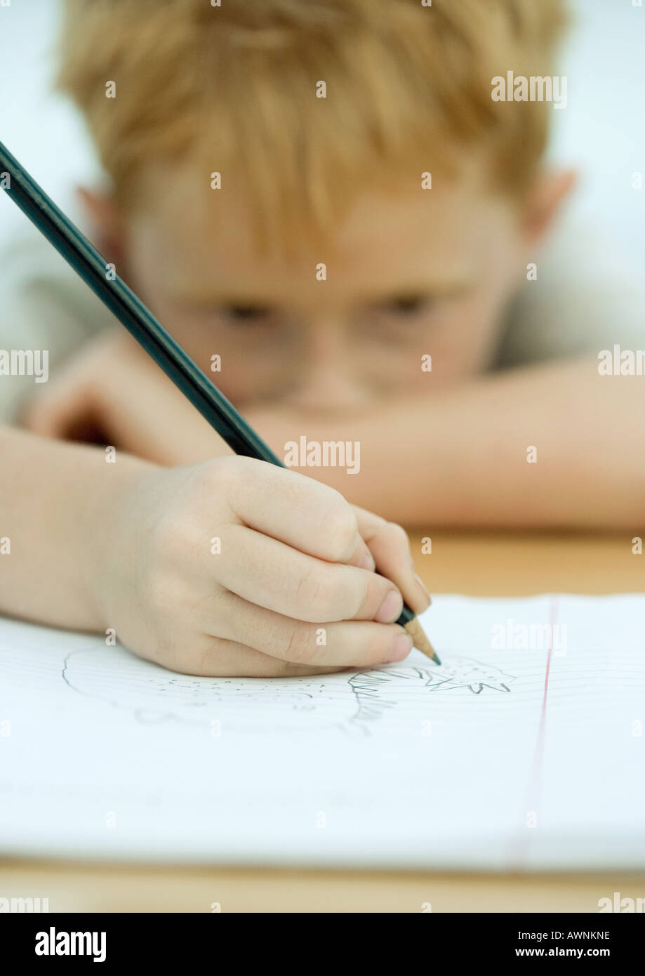 Boy drawing in notebook Stock Photo Alamy