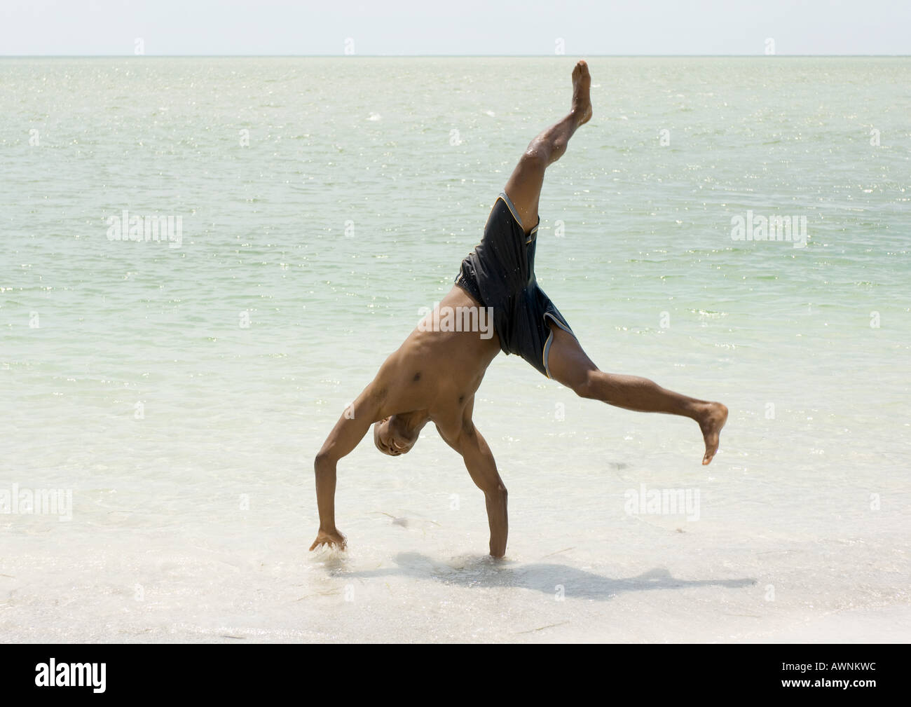 Man doing cartwheel in surf Stock Photo Alamy