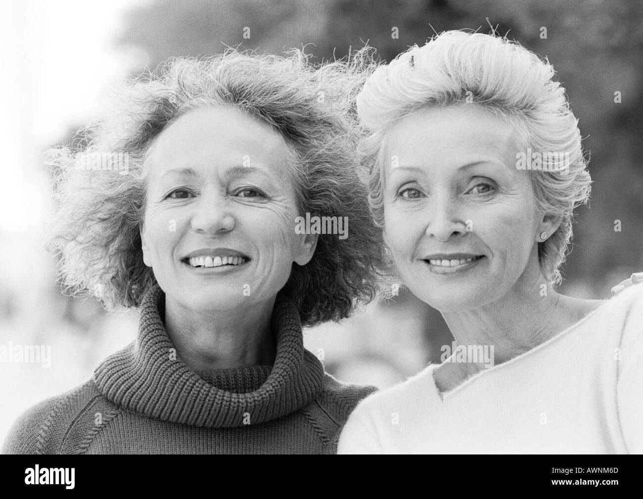 Two mature women smiling at camera, portrait, B&W Stock Photo Alamy