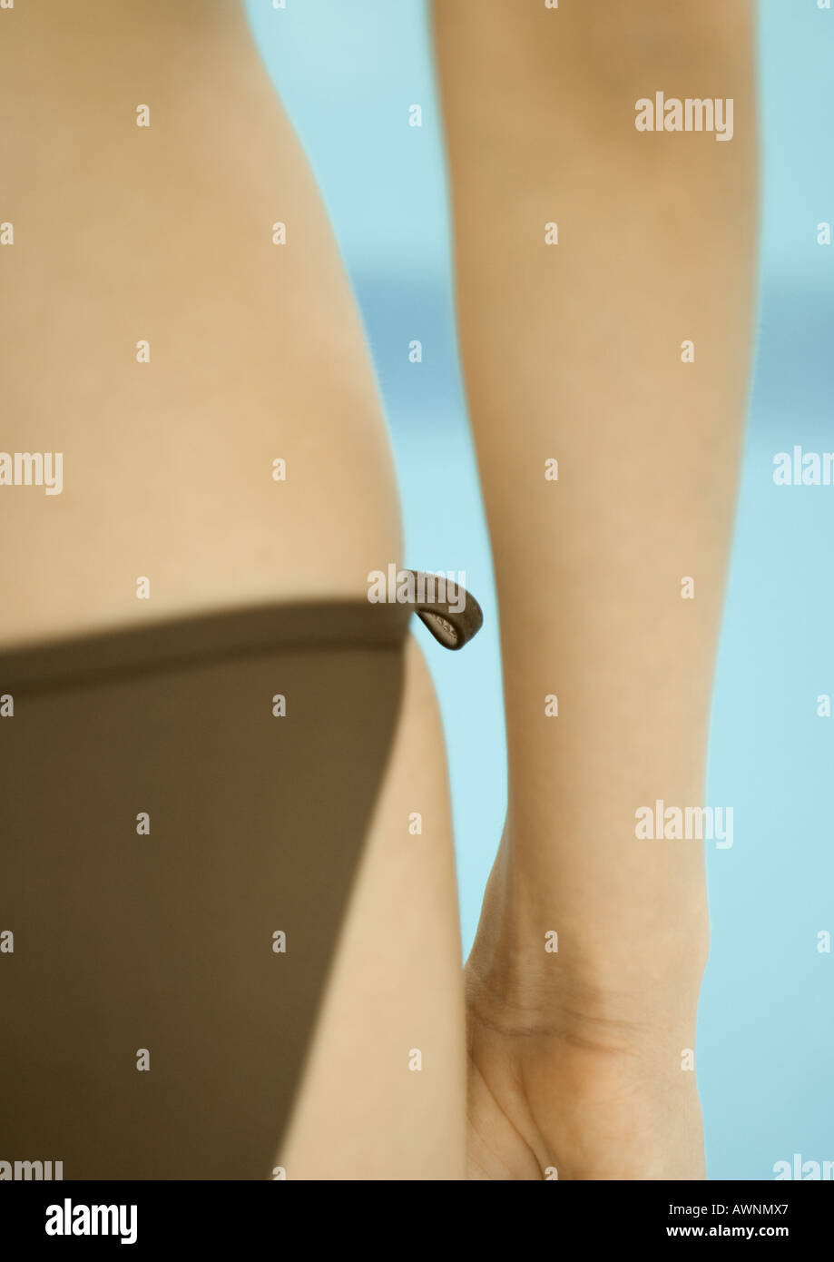 Woman wearing string bikini, close-up of hip, rear view Stock Photo