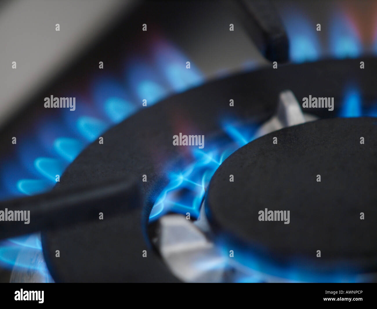 closeup of blue gas flame of stainless smeg cooker stove Stock Photo