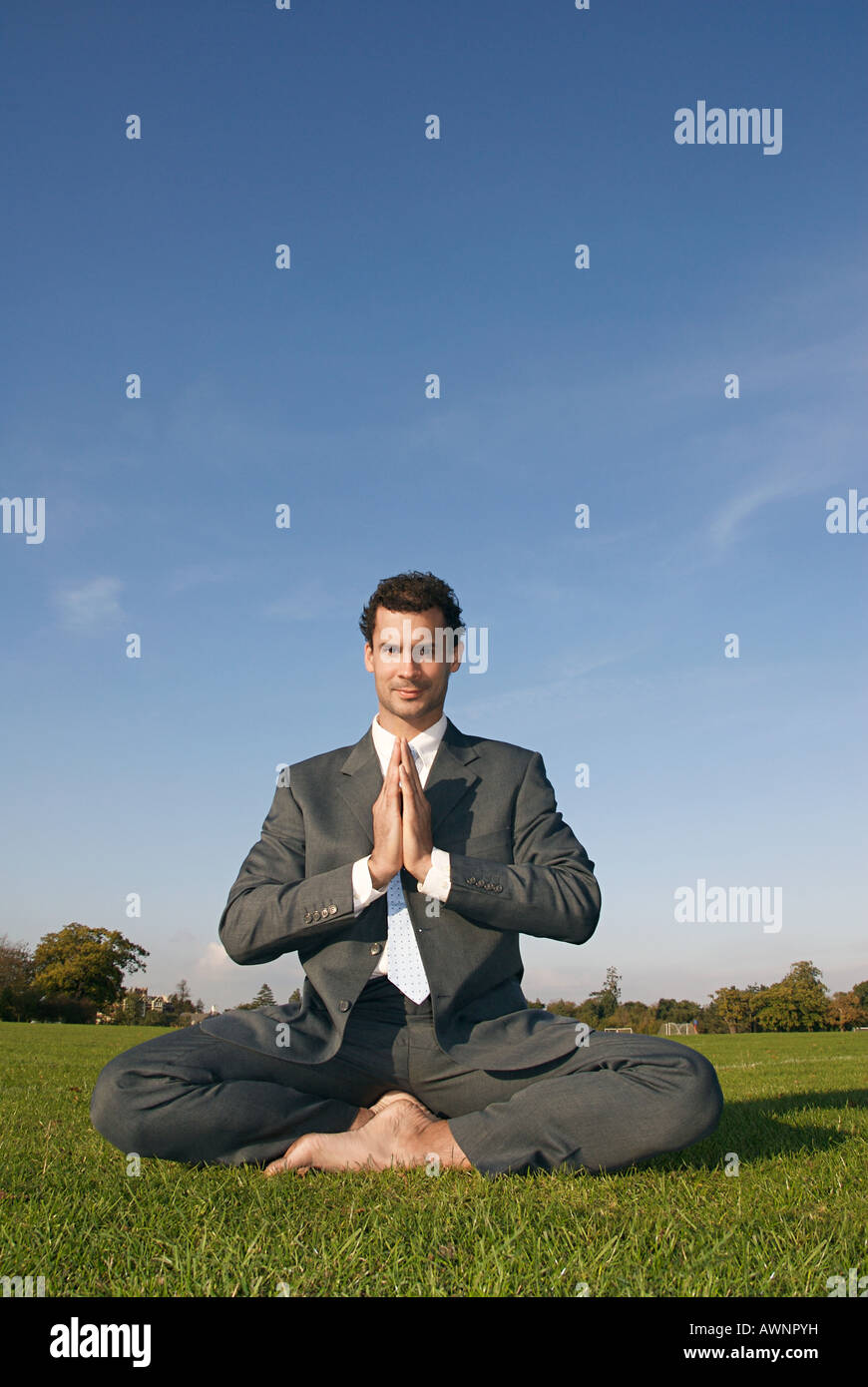 A businessman doing yoga Stock Photo - Alamy