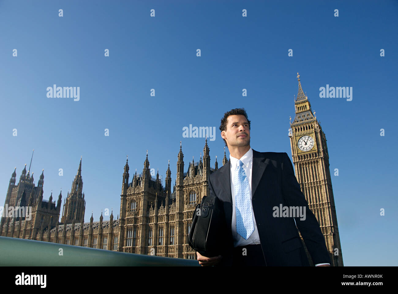 A businessman in front of the house of parliament Stock Photo