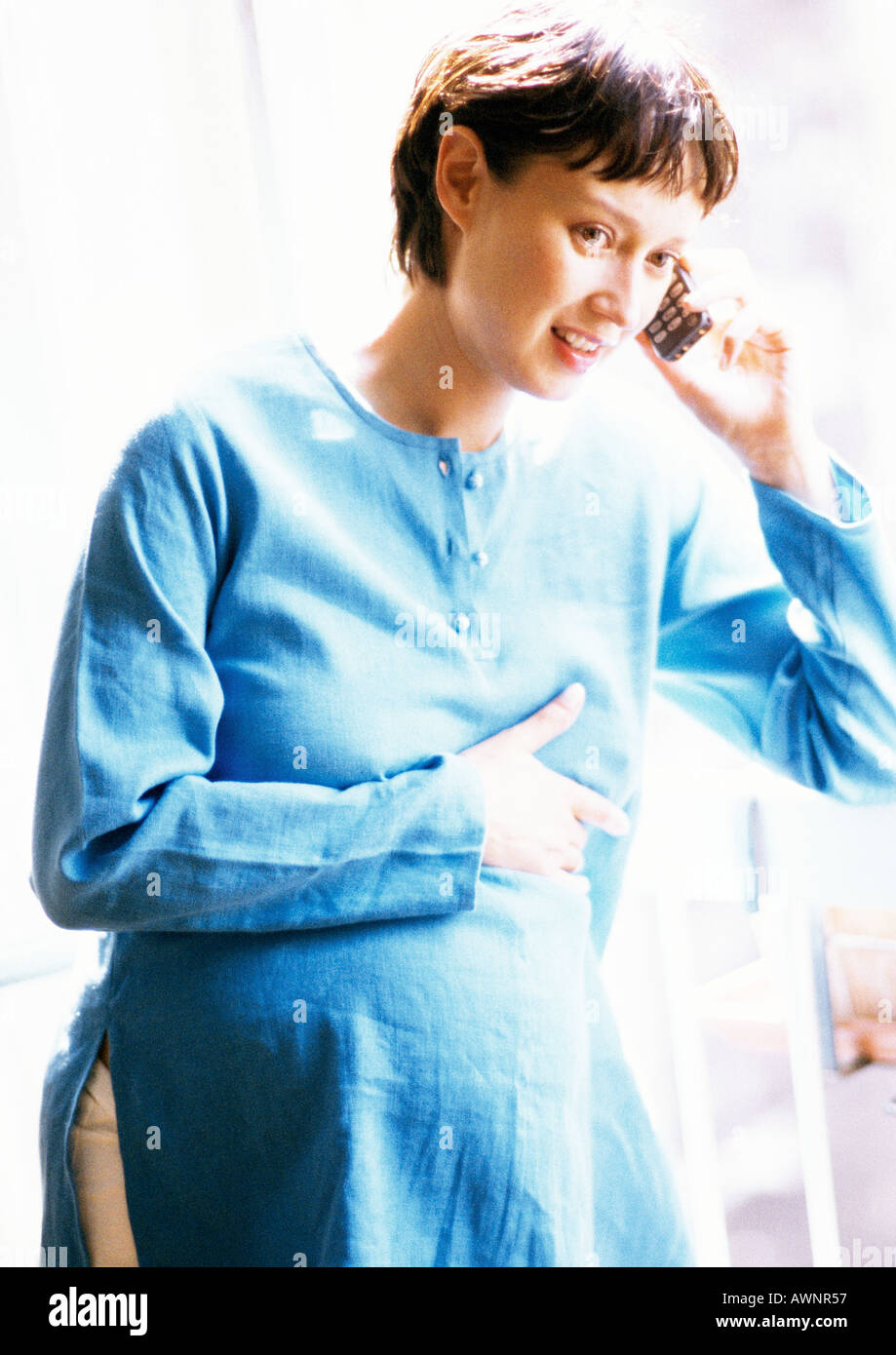 Pregnant woman using cell phone, portrait Stock Photo