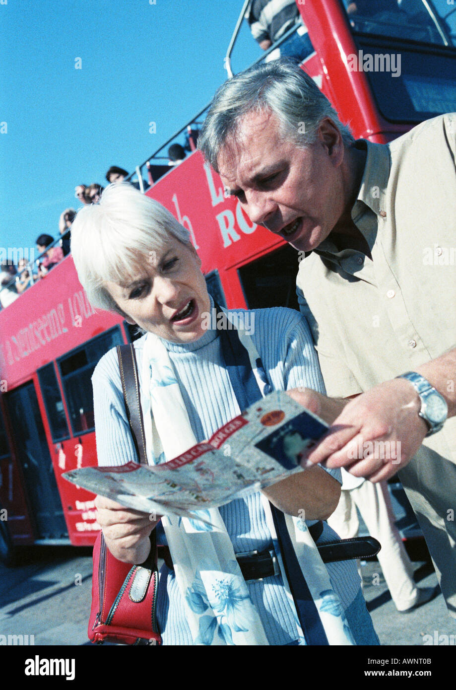 Mature woman and man examining a brochure Stock Photo