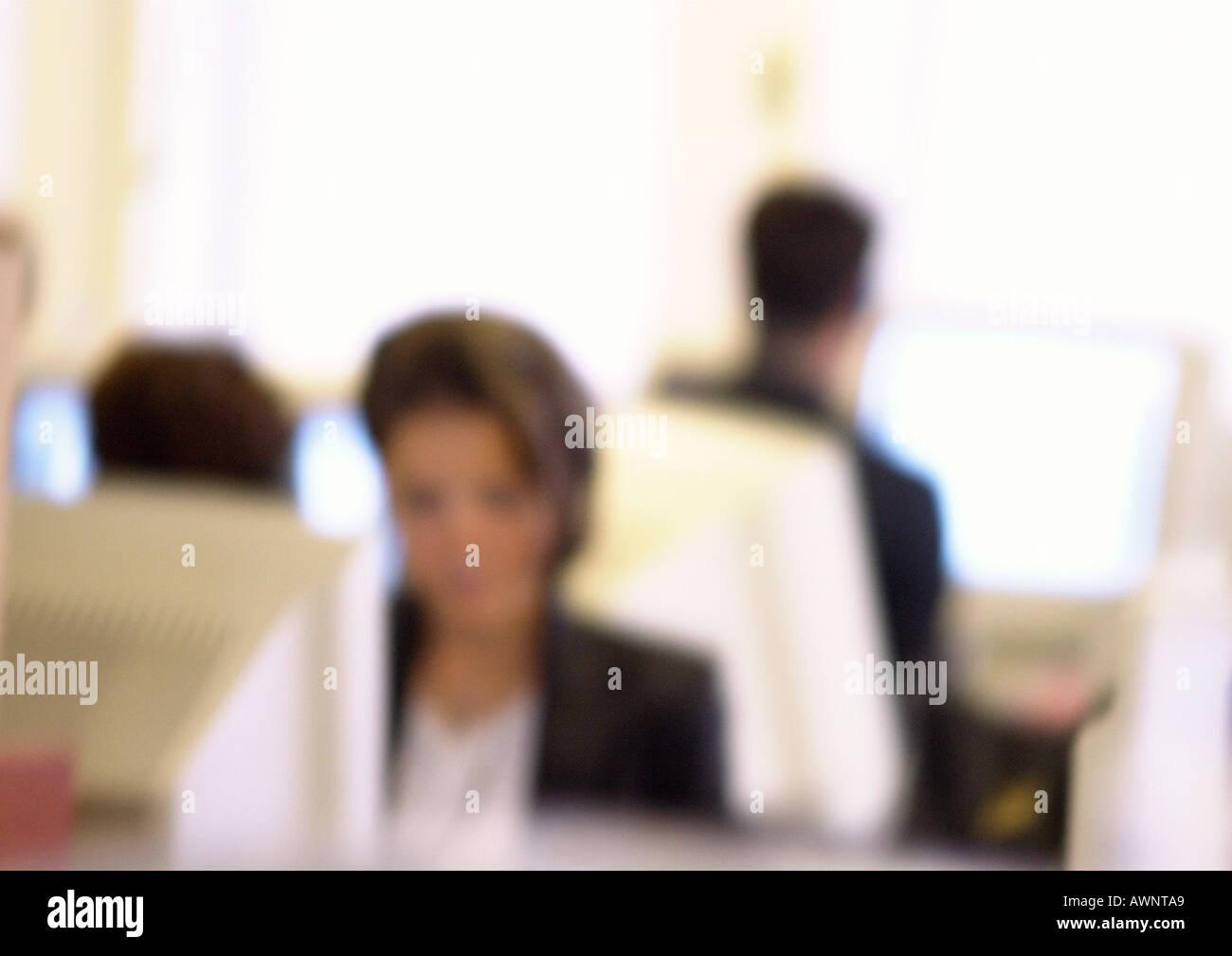 People working at computers in office, blurred Stock Photo