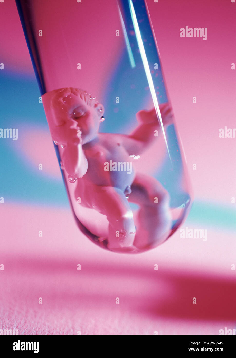 Plastic baby doll in test tube, close-up Stock Photo