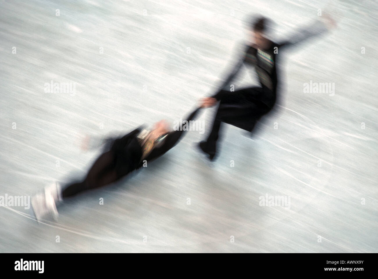 Blurred action of pairs figure skaters doing a death spiral Stock Photo