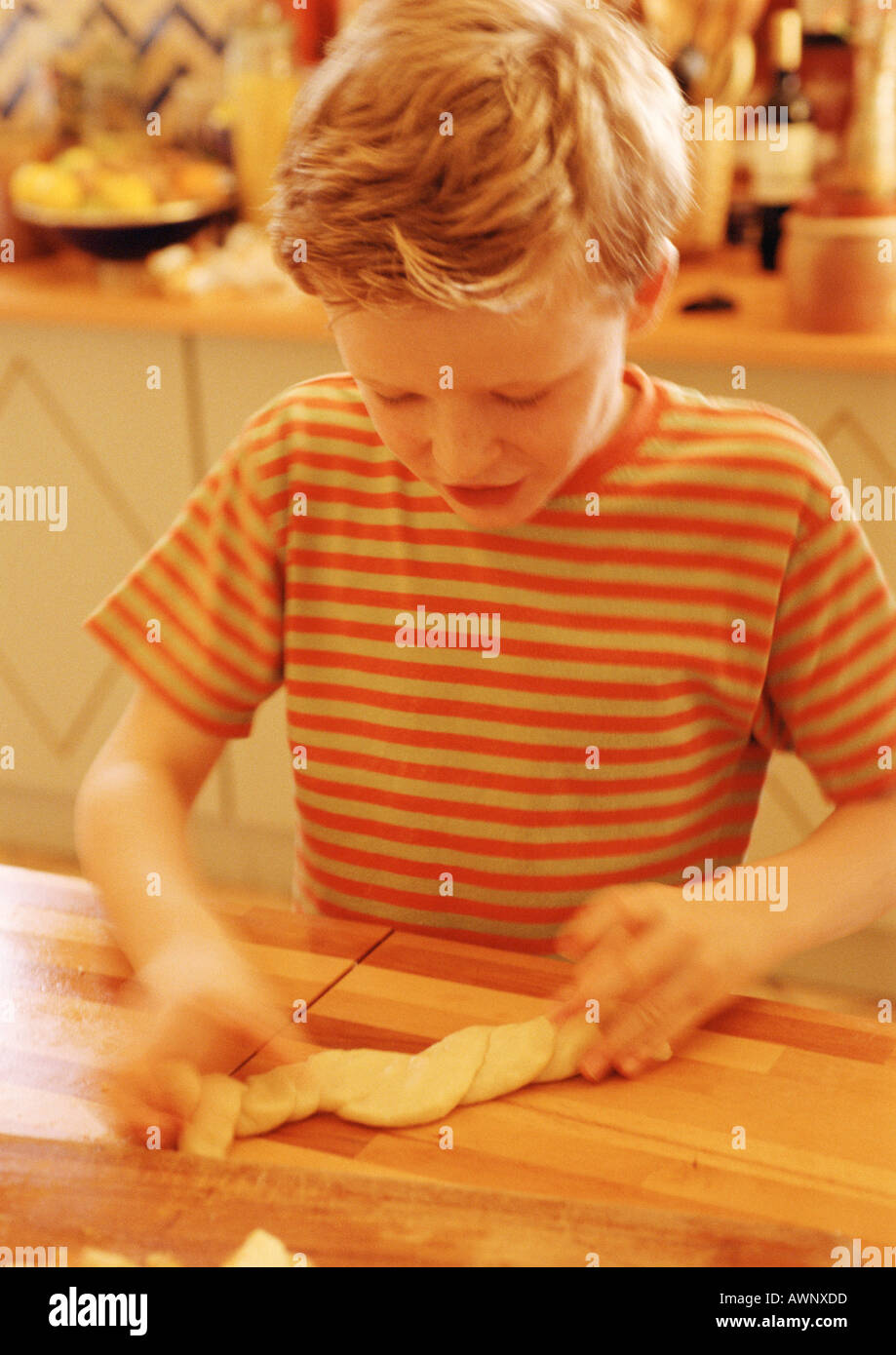 Child handling pastry dough, blurred motion Stock Photo