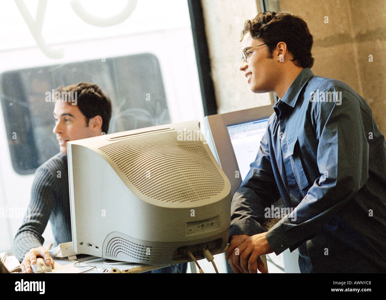 Two men in cyber cafe Stock Photo