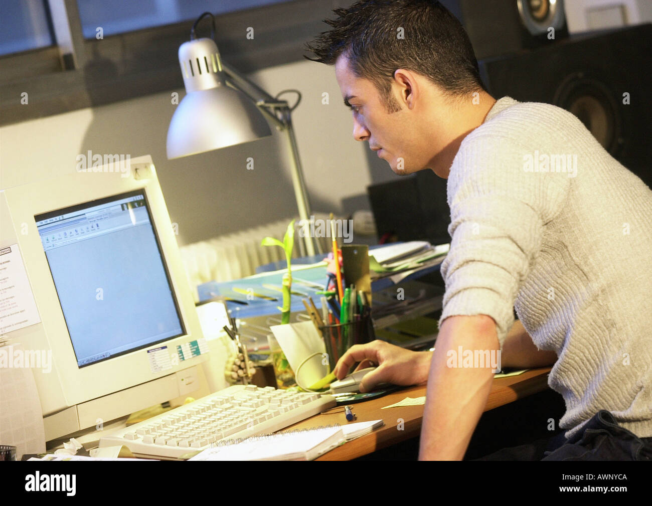Man working on computer, side view Stock Photo
