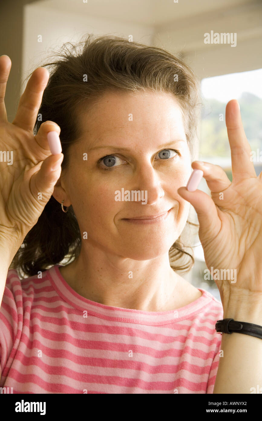 Woman holding pills Stock Photo