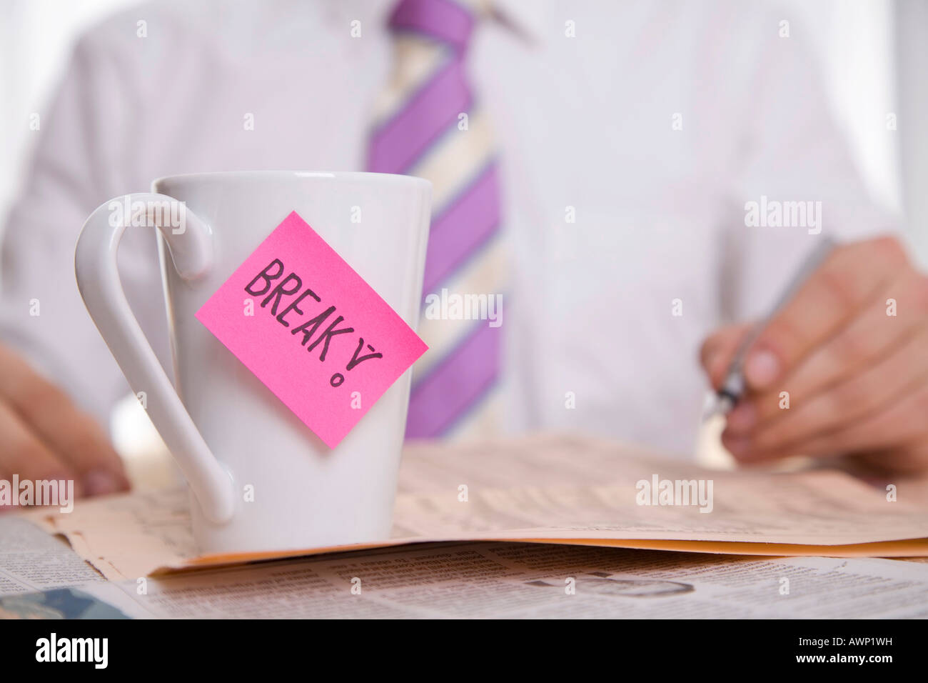 Working businessman with cup Stock Photo