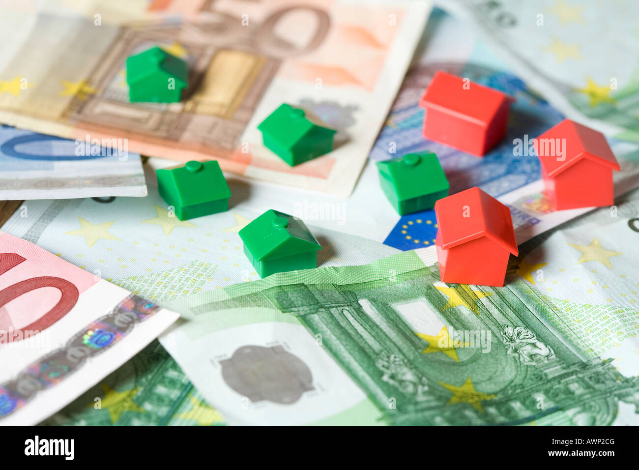 Miniature houses on money Stock Photo