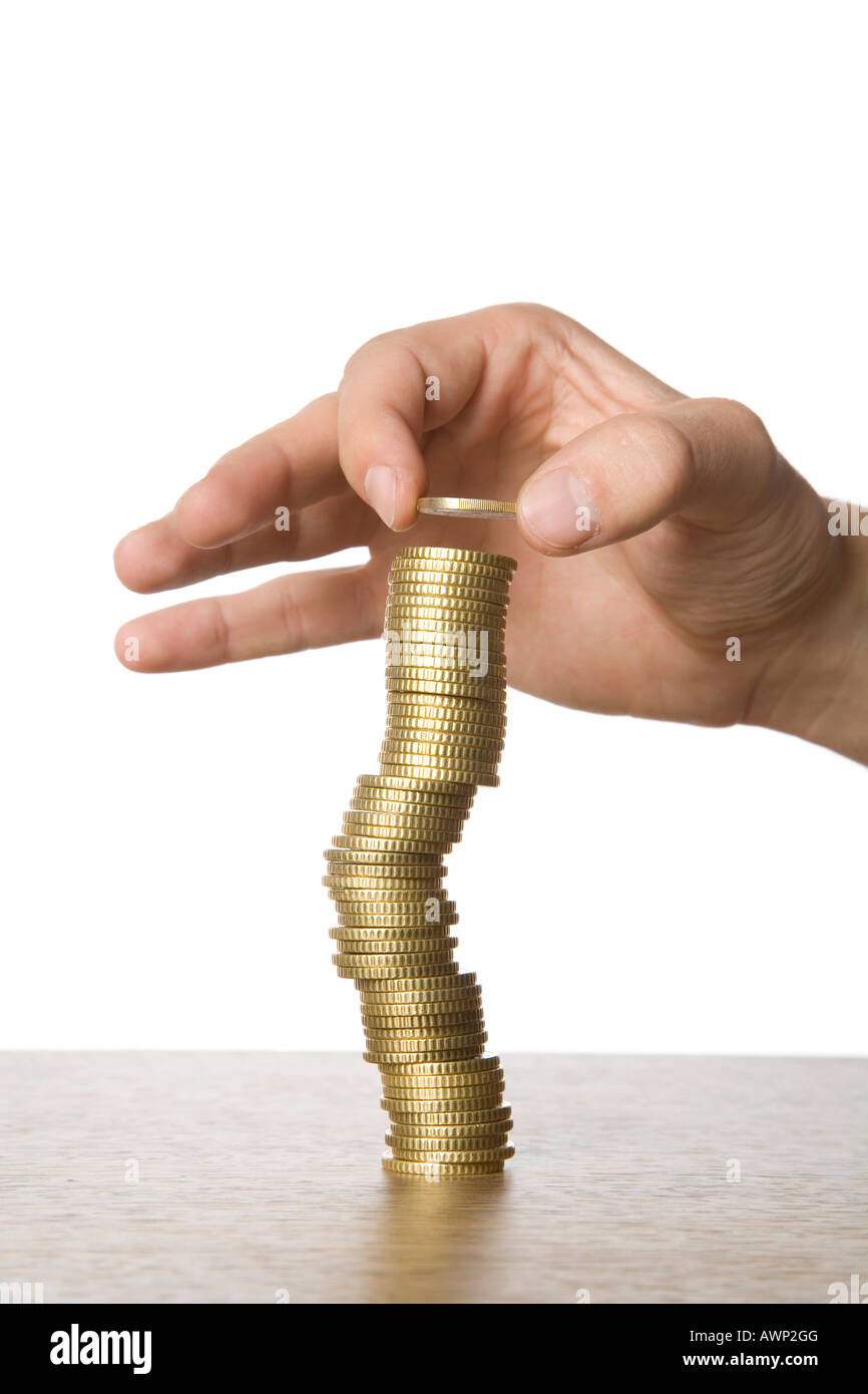 Hand stacking coins Stock Photo