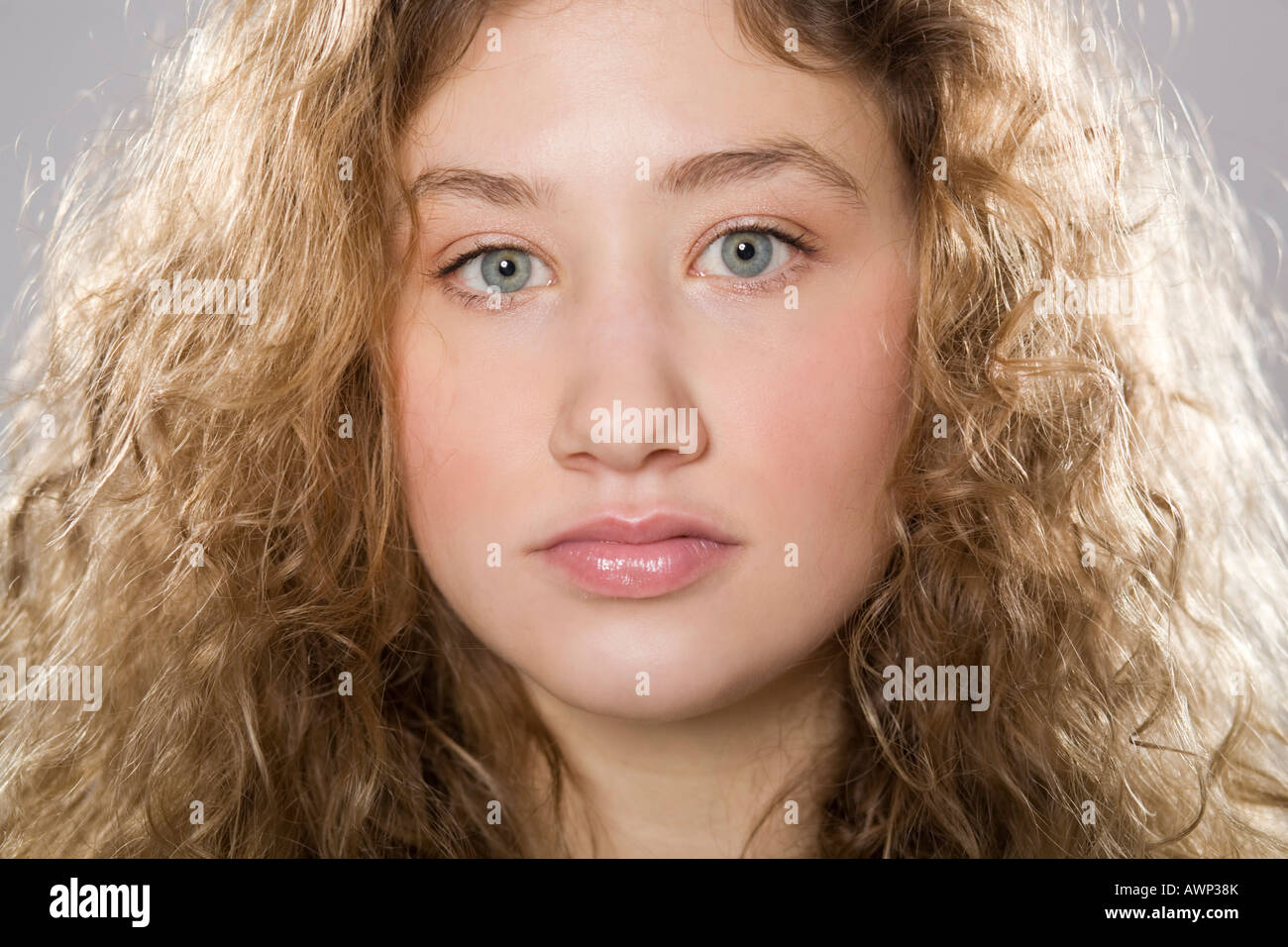Portrait of a young woman with curly hair Stock Photo - Alamy
