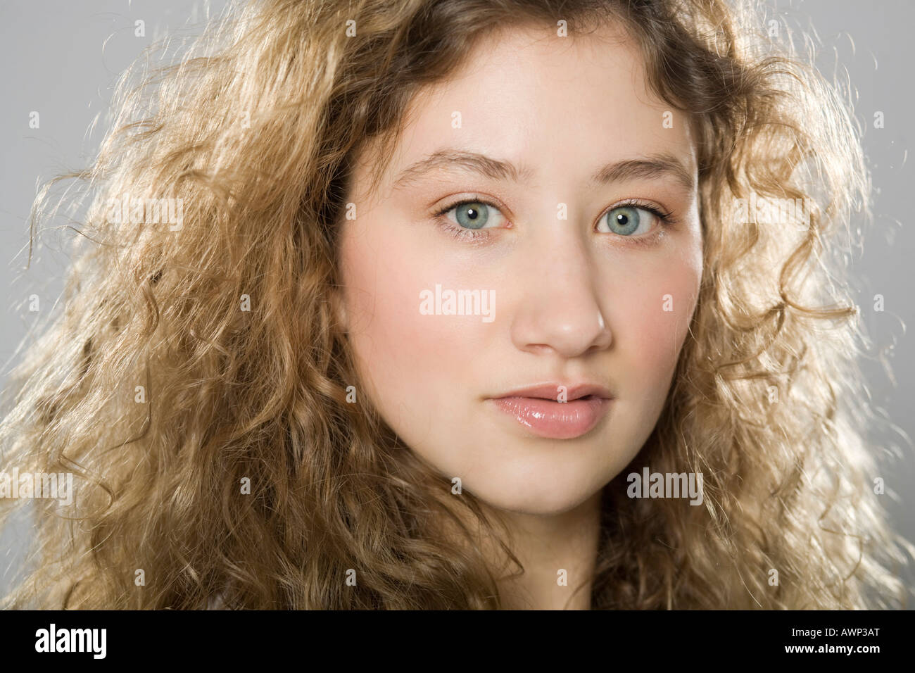 Portrait of a young woman with curly hair Stock Photo - Alamy
