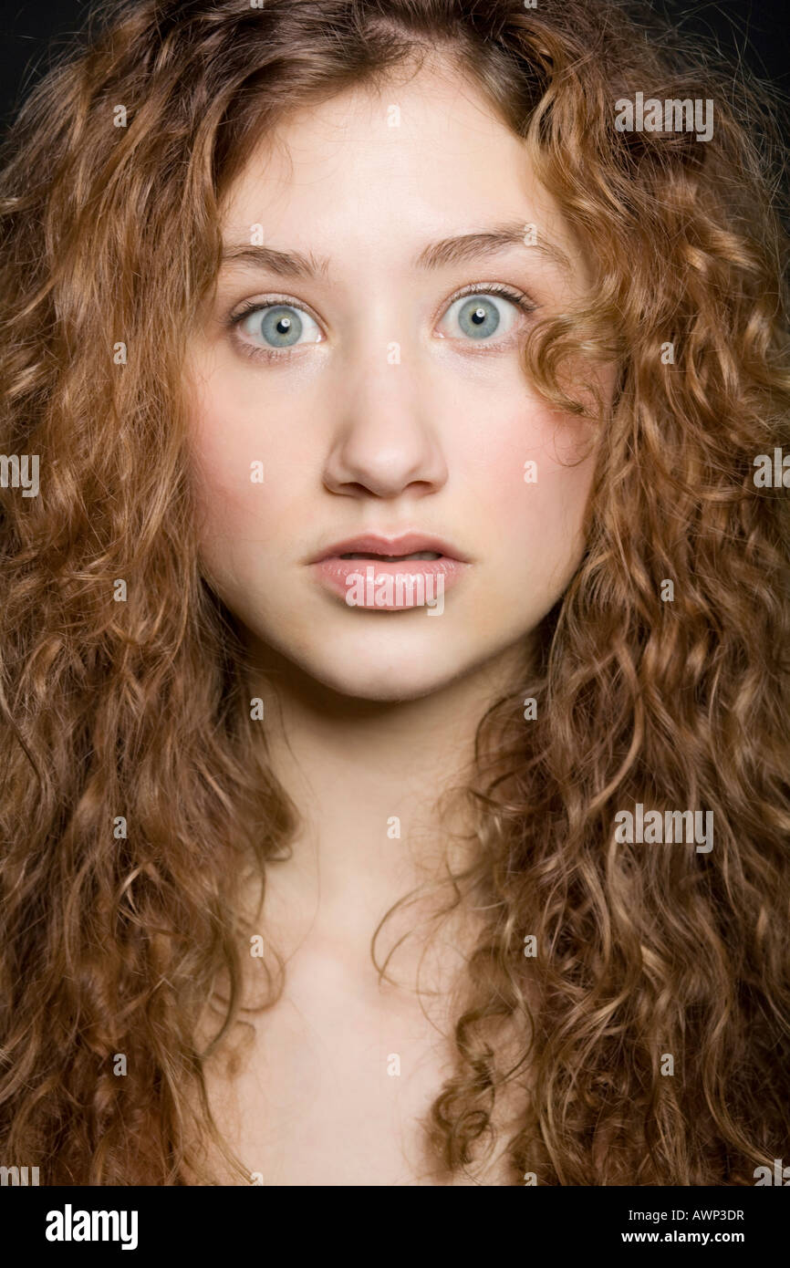 Young woman with a shocked expression on her face Stock Photo