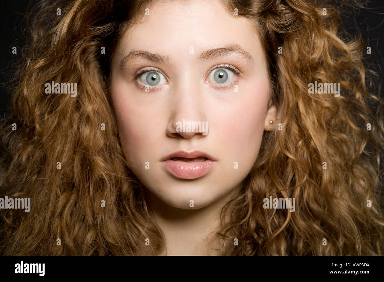 Young woman with a shocked expression on her face Stock Photo