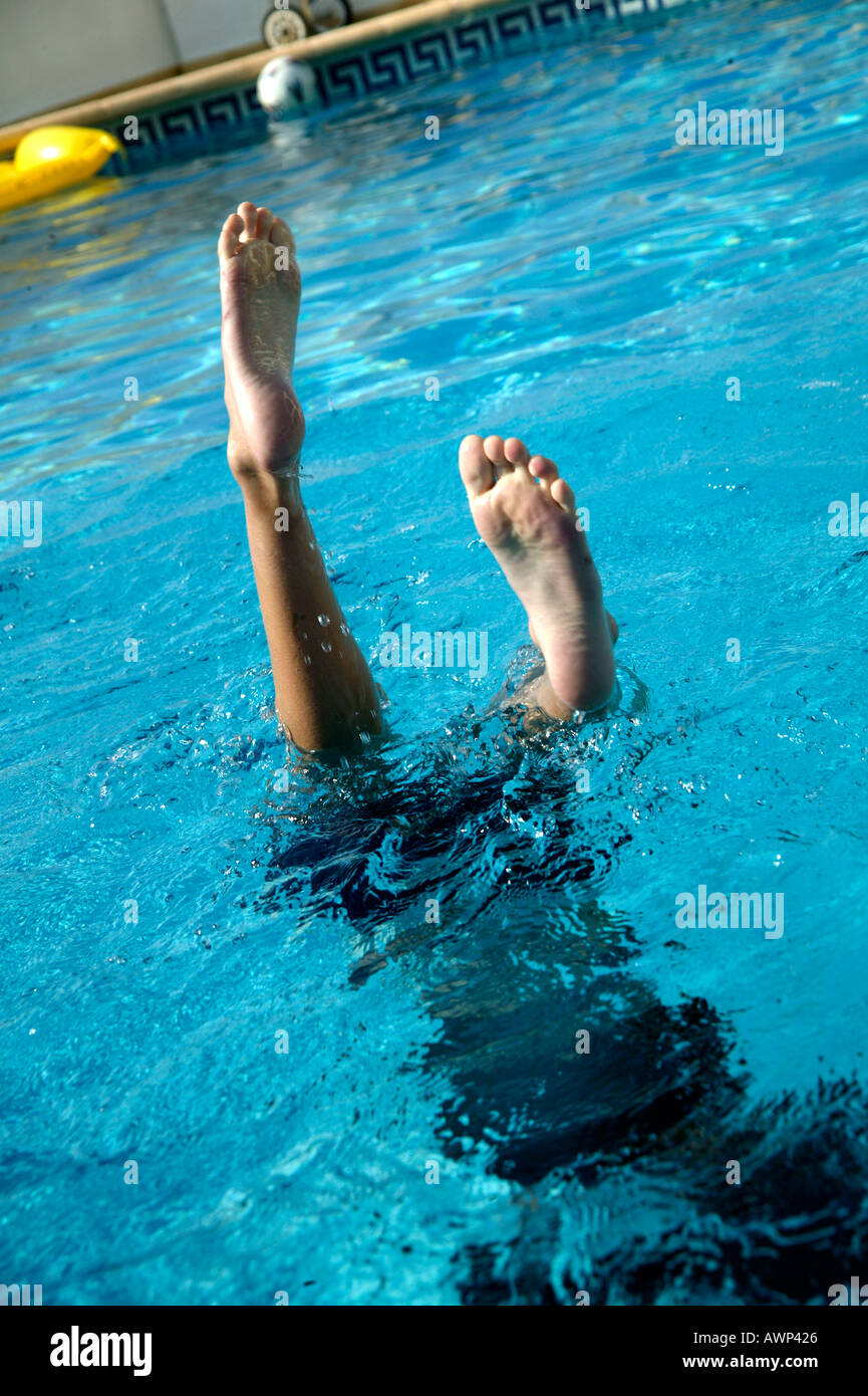 BOYS LEGS STICKING UP FROM POOL Stock Photo Alamy