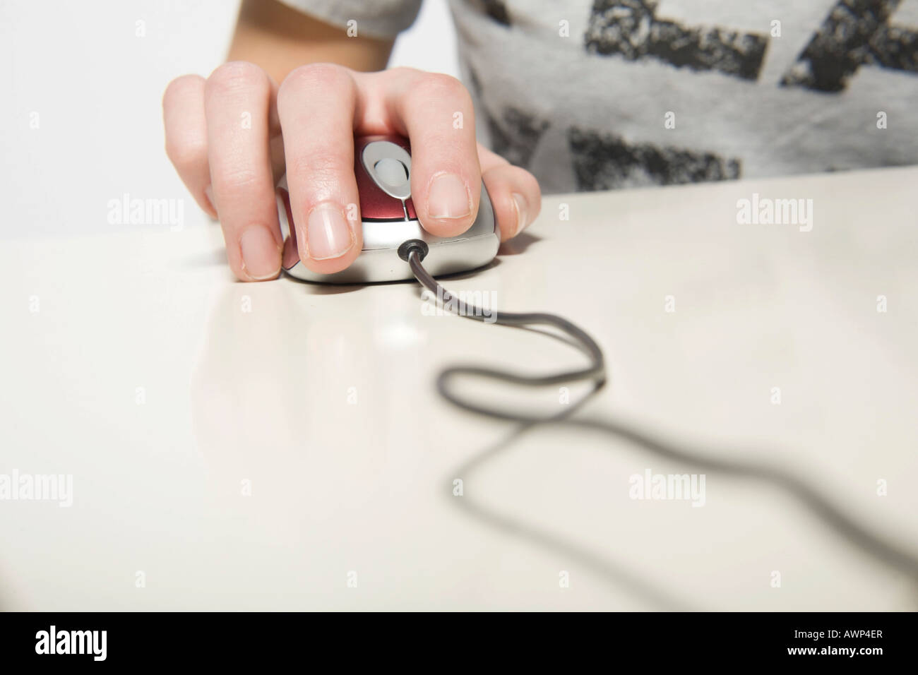 Young woman's hand on computer mouse Stock Photo