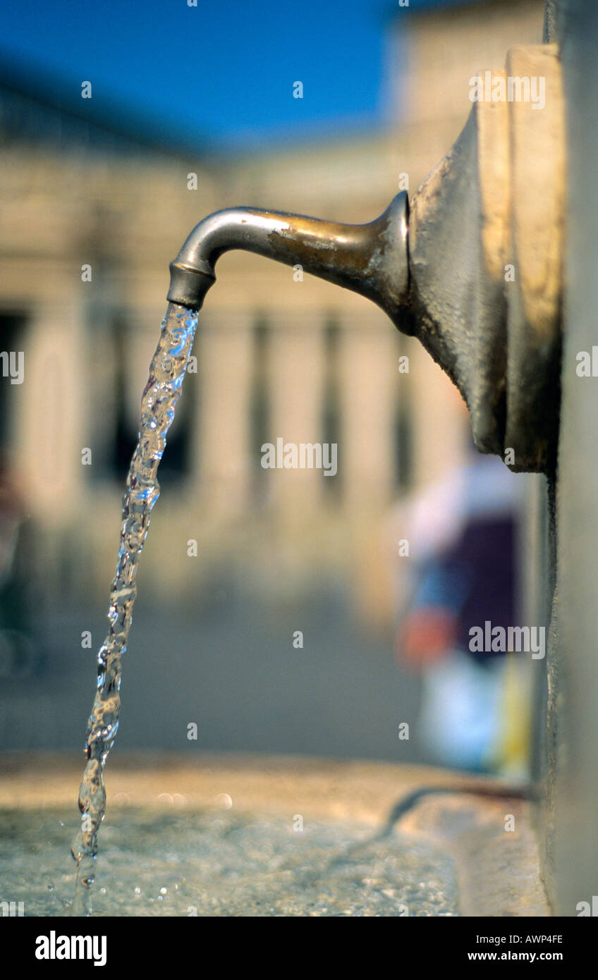 Water coming out of a spring with Saint Peter's church blurred in the background,Vatican, Rome, Italy. Stock Photo