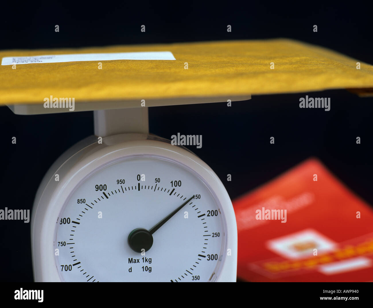 Parcel on Weigh Scales with Royal Mail leaflet blurred behind Studio