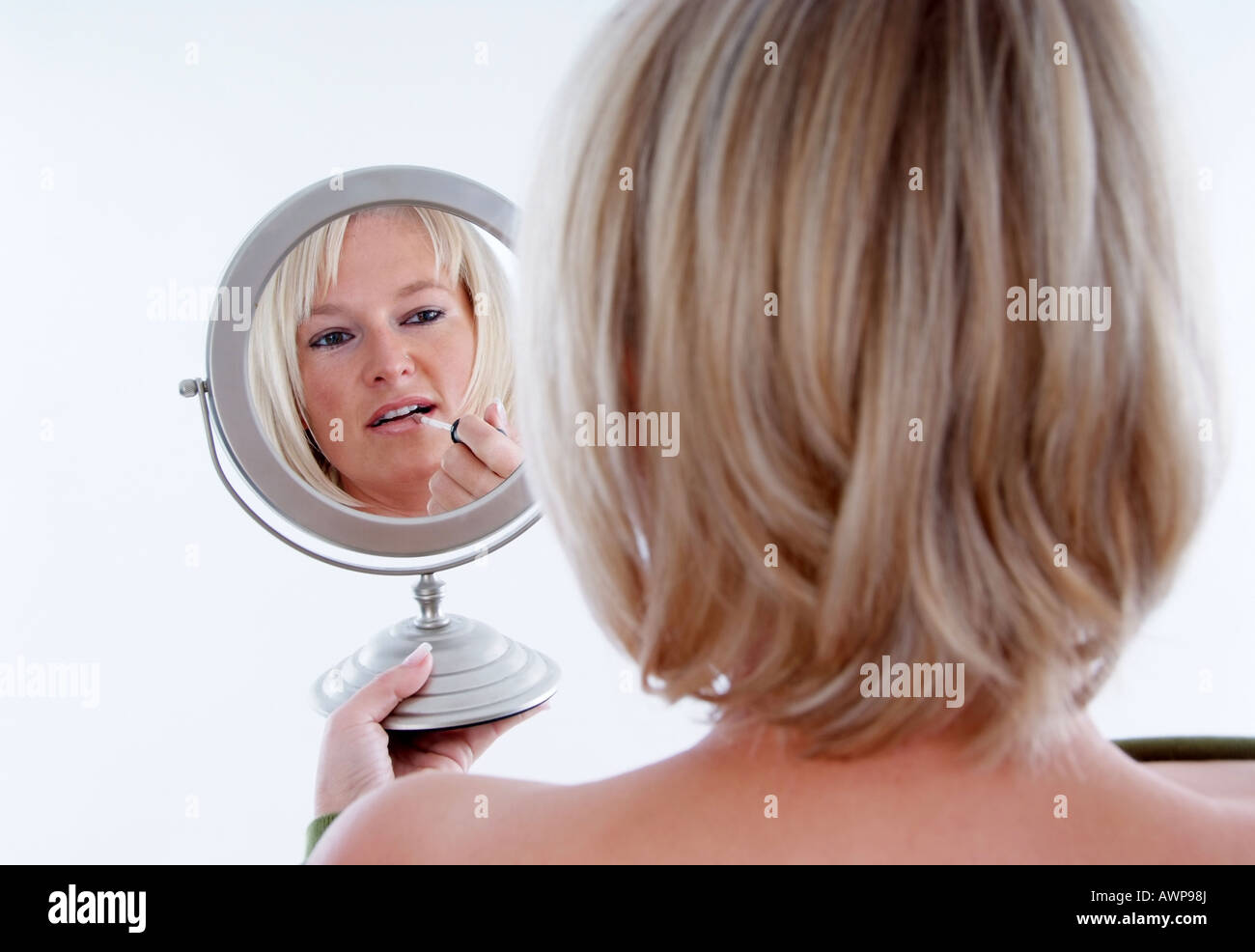woman looking into mirror Stock Photo