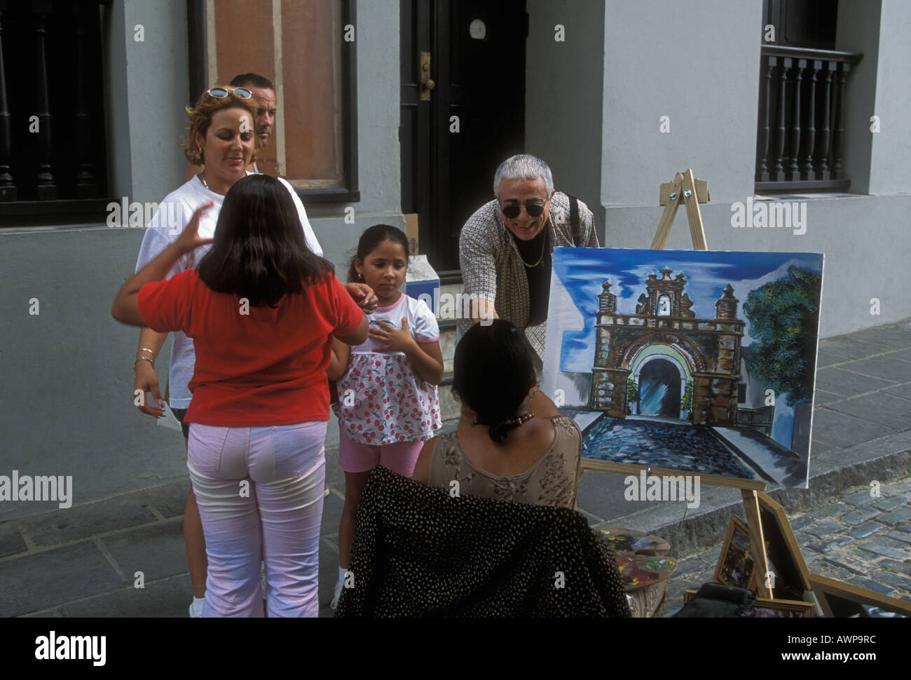 People woman painter along Calle del Cristo Old San Juan San Juan Puerto Rico West Indies Stock Photo